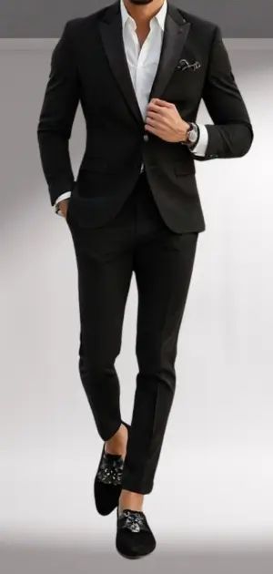 The man is wearing a slim-fit black suit with black loafers, styled for casual formal attire.