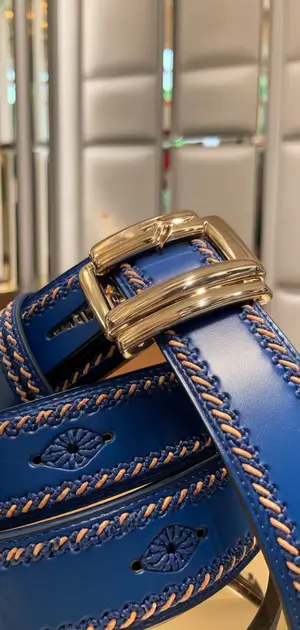Blue belt with decorative stitching and a rectangular silver buckle