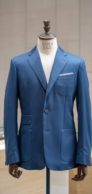 formal blue suit jacket displayed in a retail setting.Blue suit jacket with a simple, elegant design.