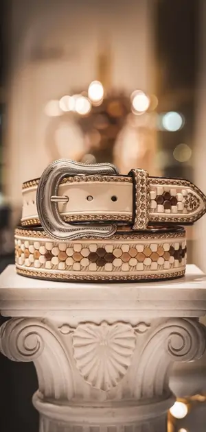 Tan bohemian belt with intricate patterns on a column