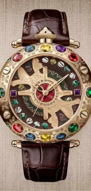 Gold bohemian watch with carved detail and a blue lapis lazuli