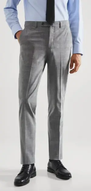 Man in light gray Calvin Klein pants and black tie