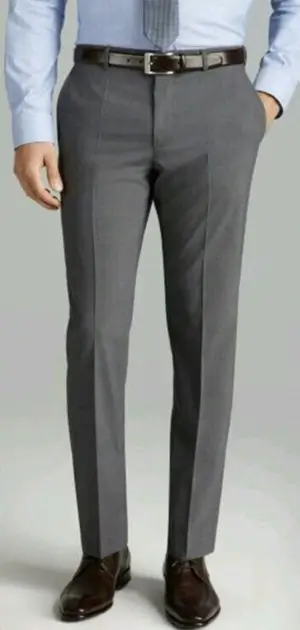 Man in dark gray Calvin Klein pants and black shoes