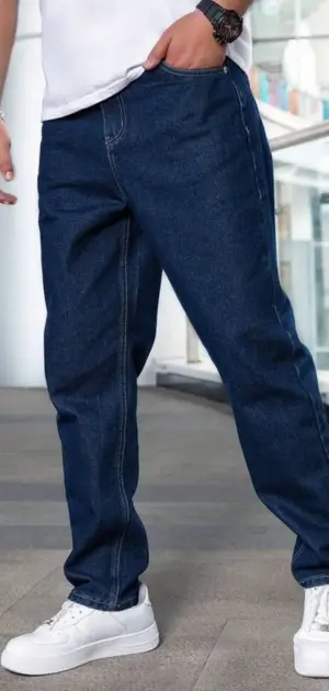 Men's minimalist dark blue jeans paired with white sneakers for modern style.