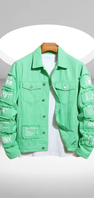 A stylish mint green denim jacket for men featuring text and patch details on the sleeves.