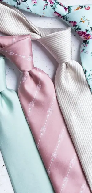 Selection of pastel ties in mint, pink, cream, and floral prints for men's fashion ties.