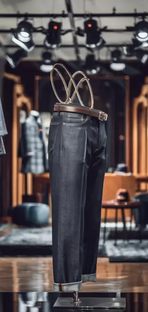 Black jeans with a belt displayed in a stylish boutique.