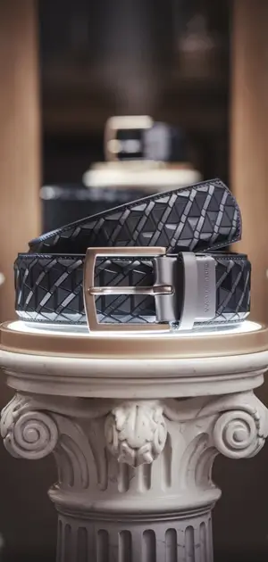 Black geometric-patterned belt with silver buckle