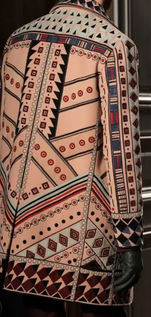 Vintage men’s coat featuring intricate patterned fabric with bold colors and elegant retro detailing.