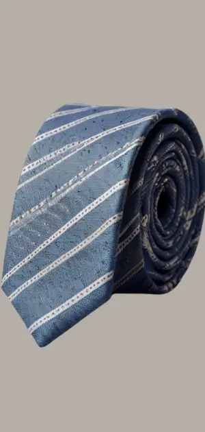 A solid green cotton tie displayed with a matching suit and tie bar.