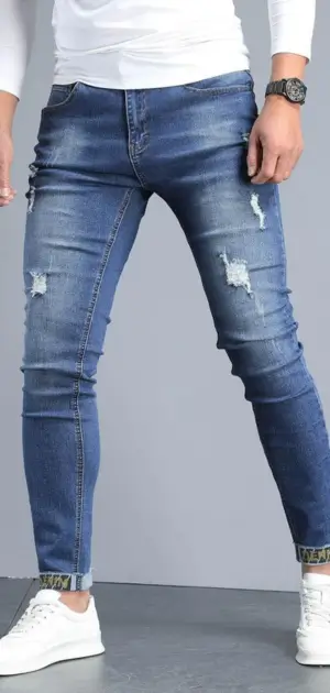 organic cotton jeans mens, A man wearing ripped, slim-fit stretch cotton jeans with a trendy appearance.