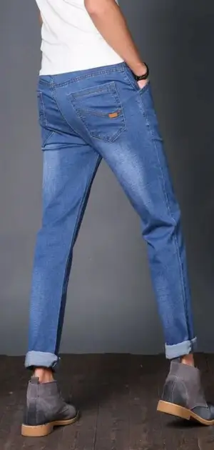 Organic cotton jeans mens A man wearing relaxed-fit cotton jeans, perfect for casual and stylish wear.
