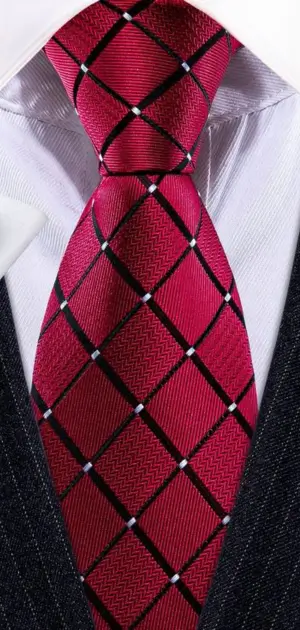 A vibrant red tie featuring a black checkered pattern, styled with a suit.