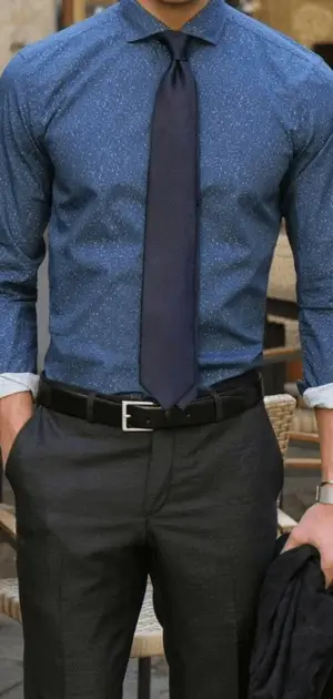 A stylish man dressed in a fitted blue travel formal wear shirts for men, ideal for business or leisure.