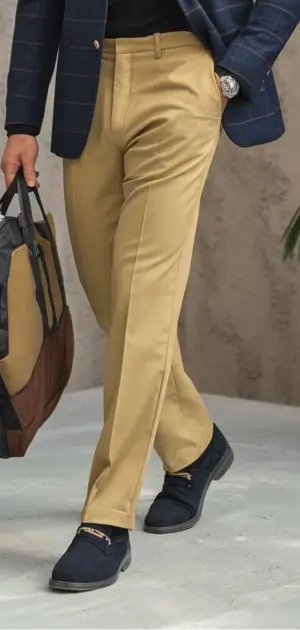 Men's lightweight travel pants beige paired with navy loafers and a casual blazer.