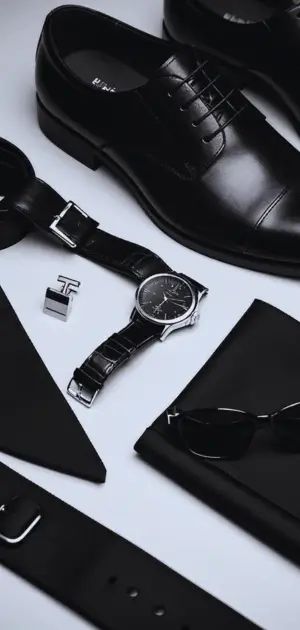 Black suit styled with necktie and polished belt