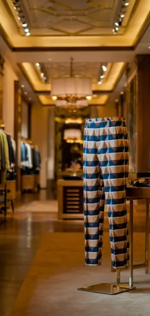 Geometric-patterned pants displayed in a luxurious boutique setting