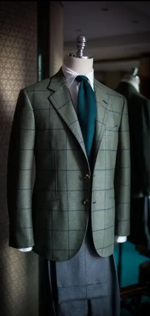 linen suits for men sale that Green checkered linen suit paired with a teal tie, displayed on a mannequin.