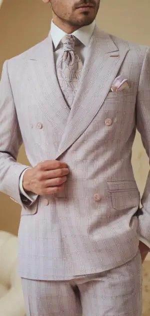 Man wearing a pastel lavender double-breasted suit with a matching tie and pocket square.