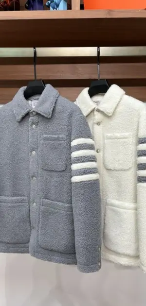 Two neutral jackets for men in grey and white, showcasing striped sleeve details.