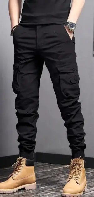 Men’s black jogger-style travel pants featuring cargo pockets and rugged boots.
