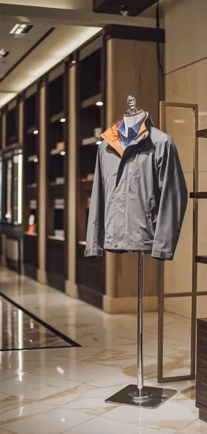 Dark gray spring jacket with orange collar detail.
