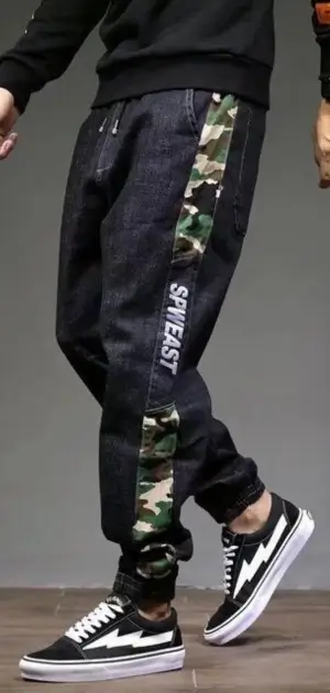 Black men’s denim jeans featuring camo side panels and a relaxed fit.