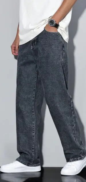 Men's relaxed-fit charcoal gray minimalist jeans paired with a white tee and sneakers.