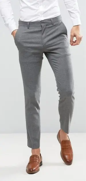 Best mens office pants Slim-fit grey office pants for men paired with a white shirt and tan loafers.