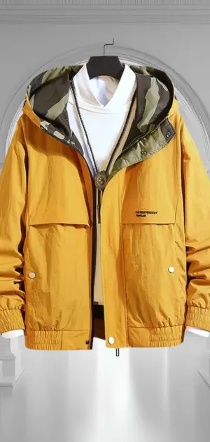 A mustard yellow pastel jacket featuring a camo-lined hood, paired with a turtleneck.