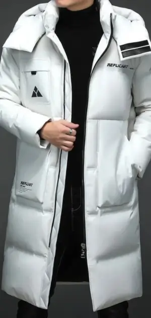 A stylish white polyester coat with graphic accents paired with a black turtleneck.