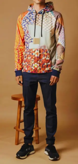 Satin-lined hoodie paired with men’s casual accessories like a watch and cap.
