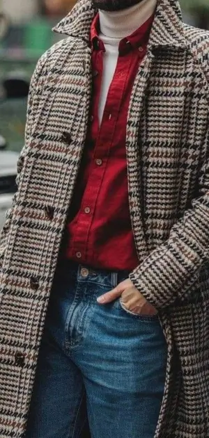 Men’s houndstooth coat paired with a striking red shirt and casual denim jeans.