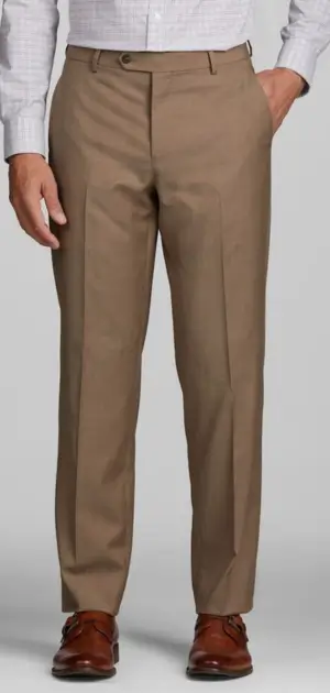Men’s tan travel pants matched with a white shirt and brown leather shoes.