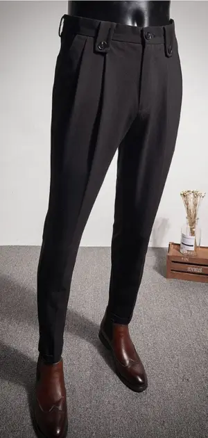 Stylish black wedding pants for men featuring pleats and a refined design.