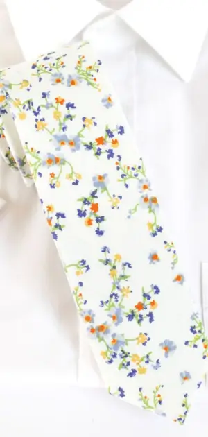 Men's white tie featuring colorful floral patterns, ideal for adding vibrancy to outfits.