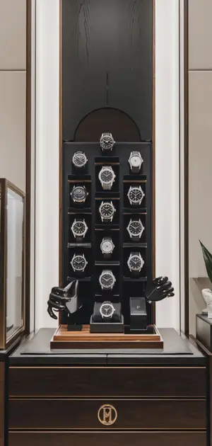 vertical display of black wristwatches arranged neatly in a luxury store