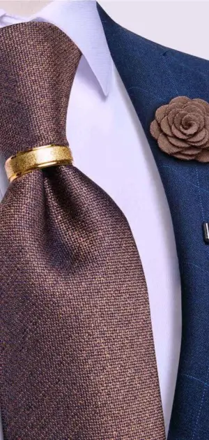 Brown textured tie paired with a blue blazer and gold clip, ideal for formal settings essential ties to own.