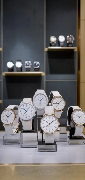 Close-up of white-faced watches with gold and silver accents