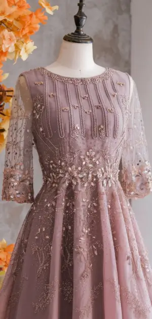 Pink A-line dress with pearl embellishments.