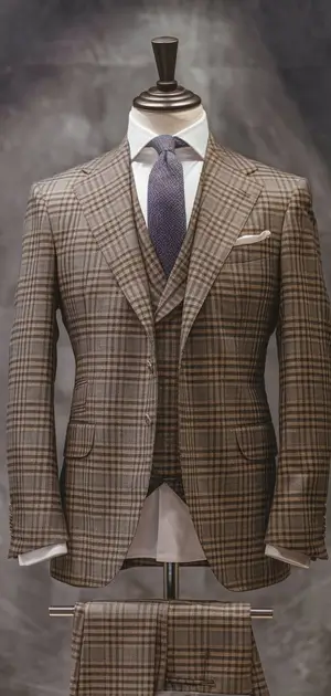 Classic check suit with red tie and black shoes on display