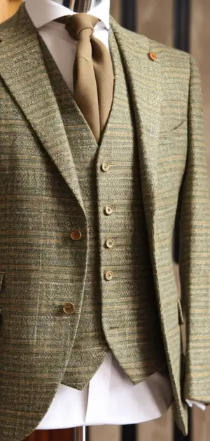 Green Donegal suit with a golden tie