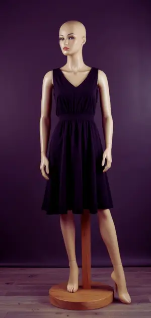 Black bodycon dress paired with statement necklace.