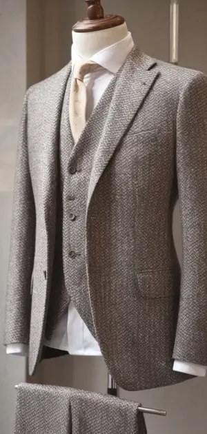Light grey herringbone three-piece suit on display