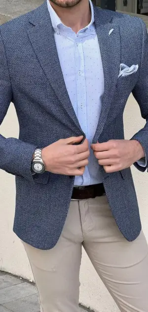 A stylish navy athletic blazer paired with a dotted shirt and beige trousers.