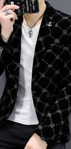 Men’s modern black plaid blazer adorned with silver motifs, styled with a white tee and bold accessories.