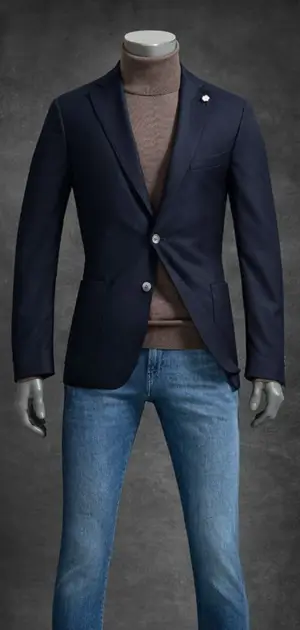 Mannequin wearing a navy solid blazer, brown turtleneck, and blue jeans for a casual-smart look.