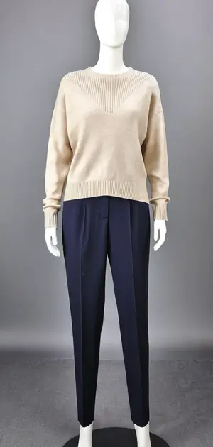 Cream sweater with white trousers on mannequin