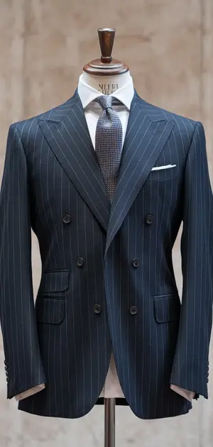 Dark blue pinstripe suit with peak lapels