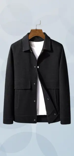 A structured black jacket with minimalist tailoring layered over a white T-shirt for a clean look.